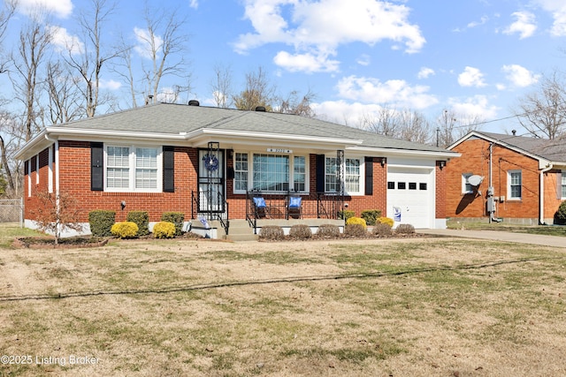 view of front of home featuring a garage, driveway, a front yard, and brick siding