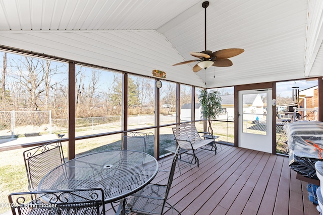 sunroom featuring lofted ceiling and a ceiling fan