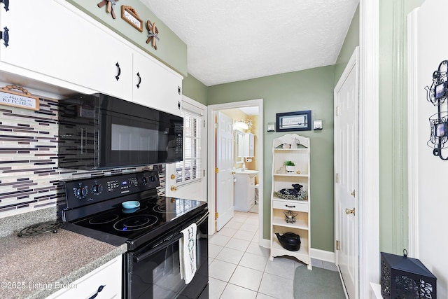 kitchen featuring light tile patterned floors, backsplash, white cabinets, a textured ceiling, and black appliances