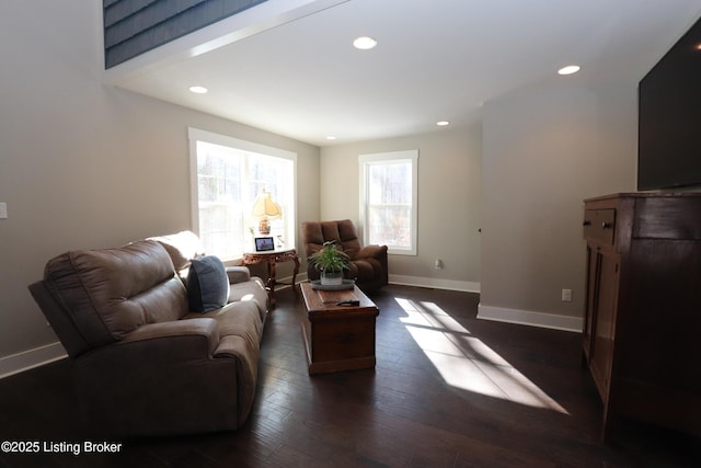 living area with dark wood-style floors, baseboards, and recessed lighting