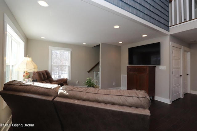 living room featuring a healthy amount of sunlight, dark wood-style floors, and recessed lighting