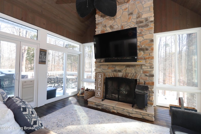 living area featuring lofted ceiling, dark wood-style floors, wood ceiling, and a fireplace