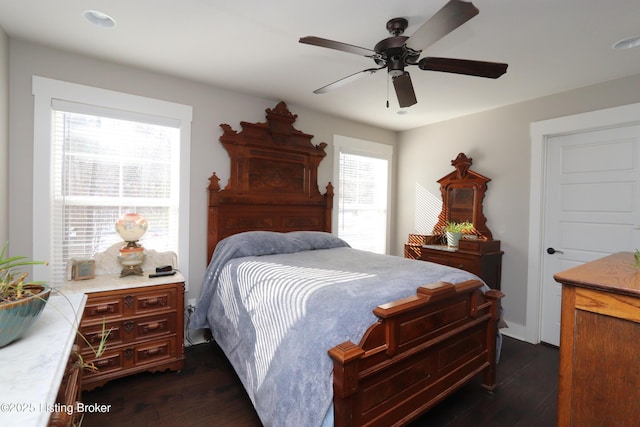 bedroom with a ceiling fan and dark wood-type flooring