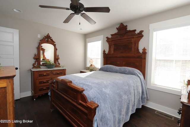 bedroom featuring dark wood-style floors, visible vents, baseboards, and multiple windows