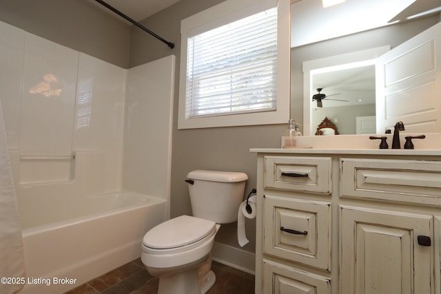 bathroom with shower / washtub combination, baseboards, a sink, and toilet