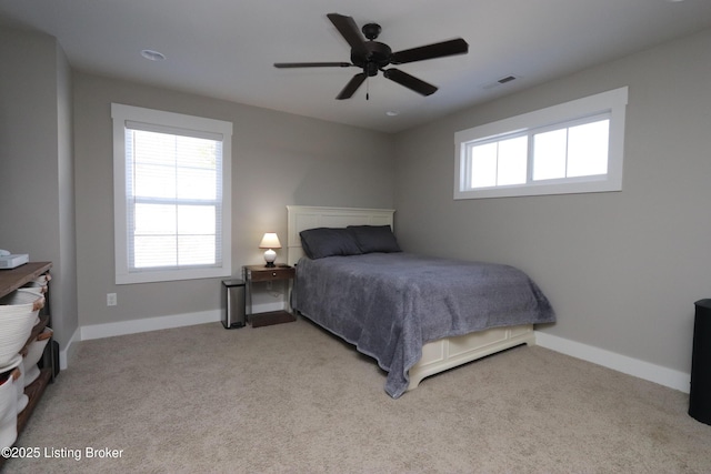 bedroom featuring baseboards, multiple windows, and visible vents