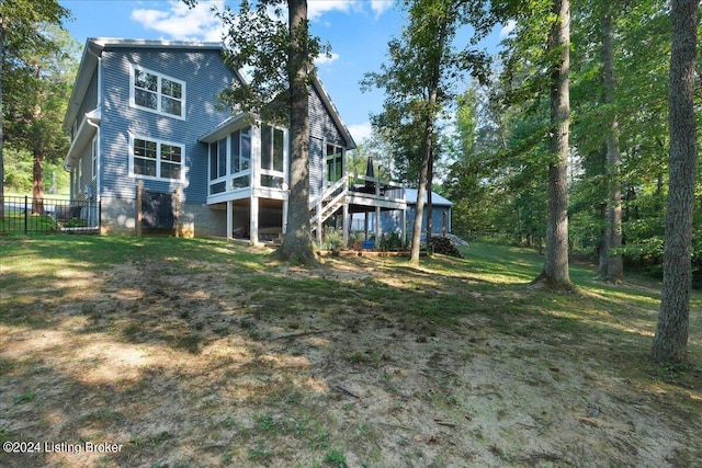 back of house with a yard, stairway, a sunroom, fence, and a wooden deck