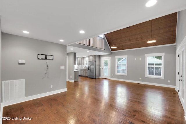 170 Moutardier Woods Way, Leitchfield, KY 42754 - unfurnished living room featuring lofted ceiling, baseboards, dark wood-type flooring, and recessed lighting