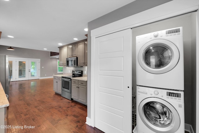 170 Moutardier Woods Way, Leitchfield, KY 42754 - washroom featuring stacked washing machine and dryer, dark wood-type flooring, recessed lighting, french doors, and baseboards