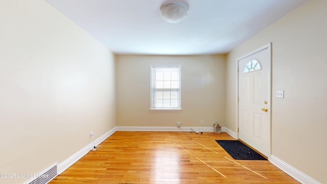 foyer entrance with light wood-type flooring and baseboards