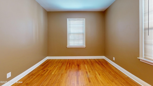 unfurnished room with light wood finished floors and baseboards