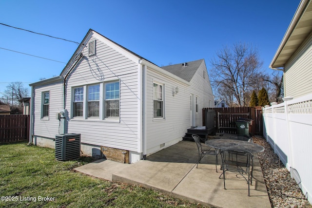 rear view of property with crawl space, a fenced backyard, cooling unit, and a patio