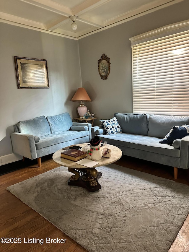 living area with coffered ceiling and wood finished floors