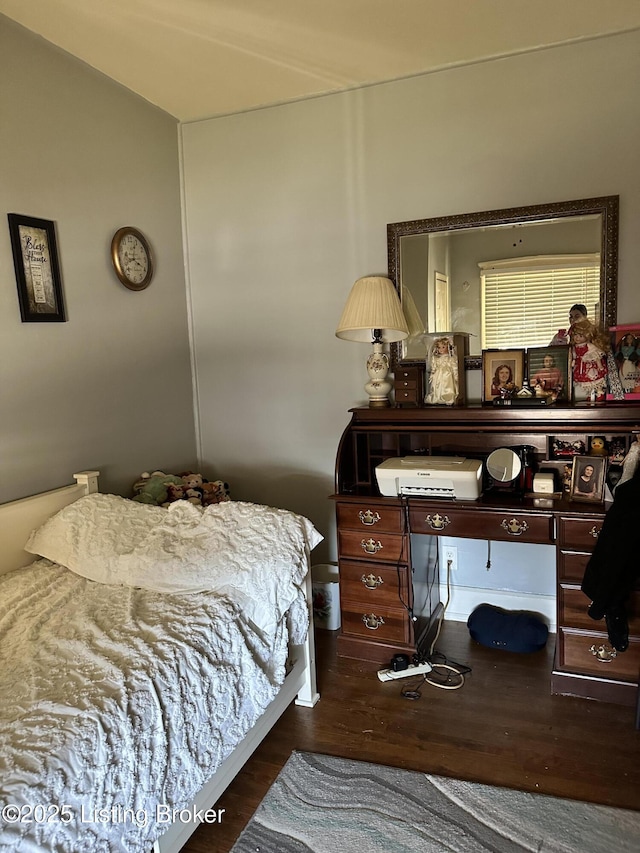 bedroom with dark wood finished floors