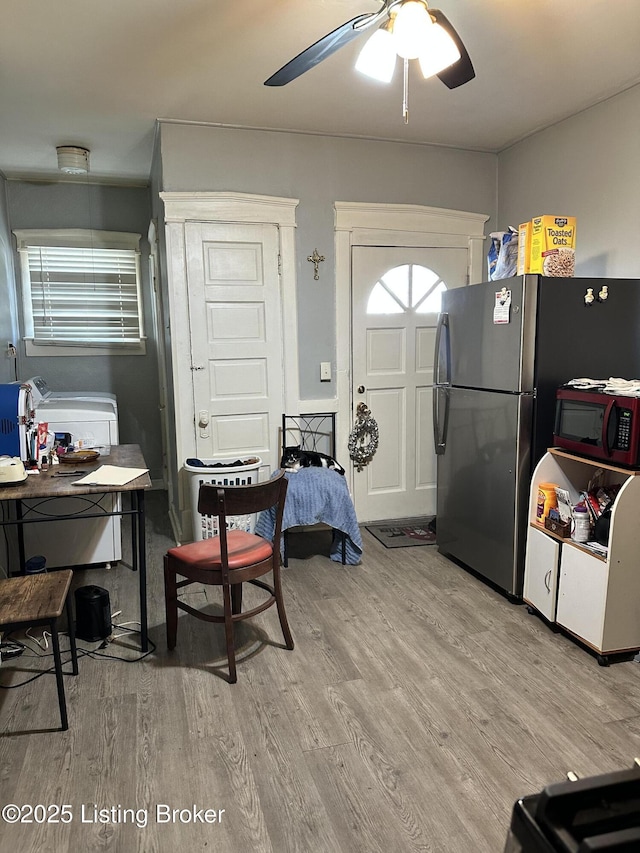 kitchen with freestanding refrigerator, ceiling fan, and light wood finished floors