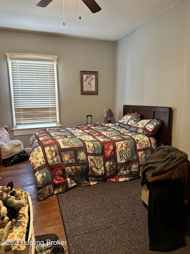 bedroom with ceiling fan and wood finished floors