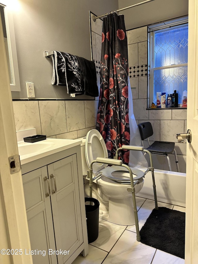 bathroom featuring shower / bath combo, tile walls, toilet, and vanity