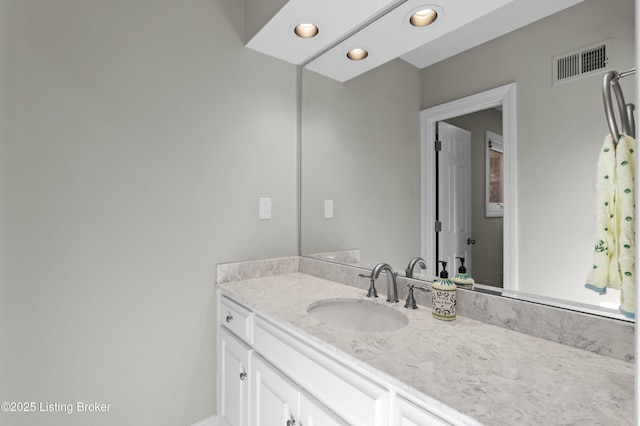 bathroom featuring recessed lighting, visible vents, and vanity