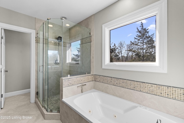 bathroom with tile patterned flooring, baseboards, a shower stall, and a whirlpool tub