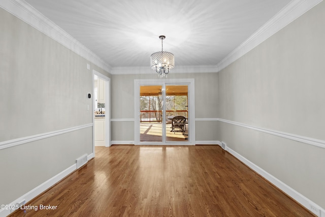 unfurnished dining area with wood finished floors, visible vents, baseboards, and an inviting chandelier