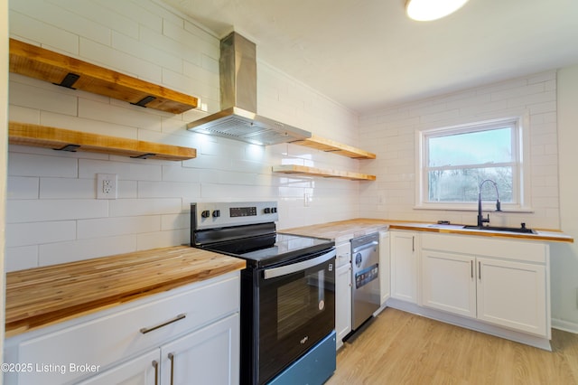 kitchen featuring open shelves, butcher block counters, appliances with stainless steel finishes, a sink, and extractor fan