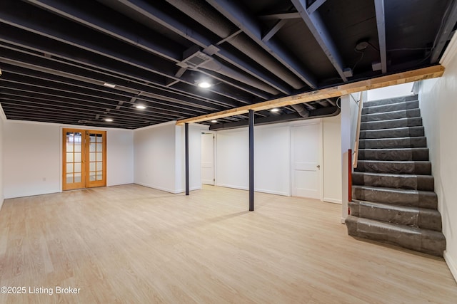 basement featuring stairs, visible vents, wood finished floors, and french doors