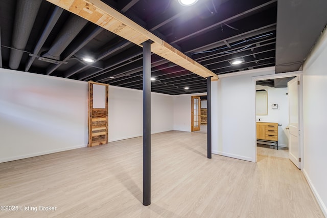 finished basement featuring wood finished floors and baseboards