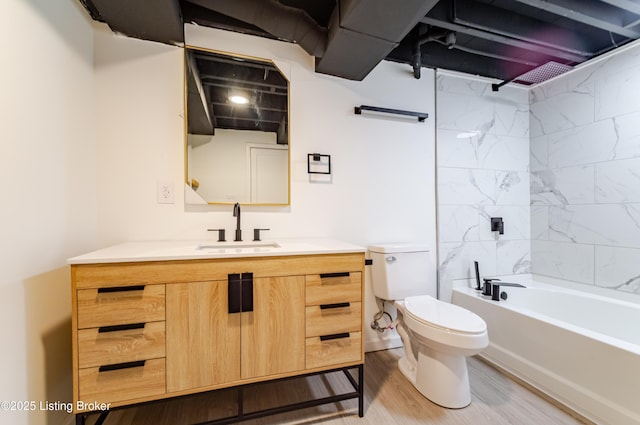 full bathroom featuring toilet, bathtub / shower combination, wood finished floors, and vanity