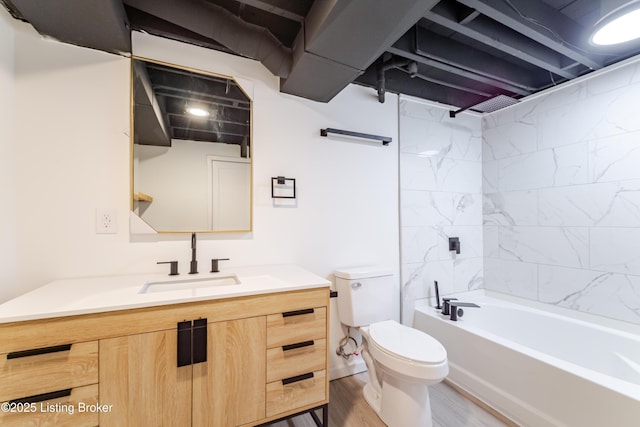 bathroom with tub / shower combination, vanity, toilet, and wood finished floors