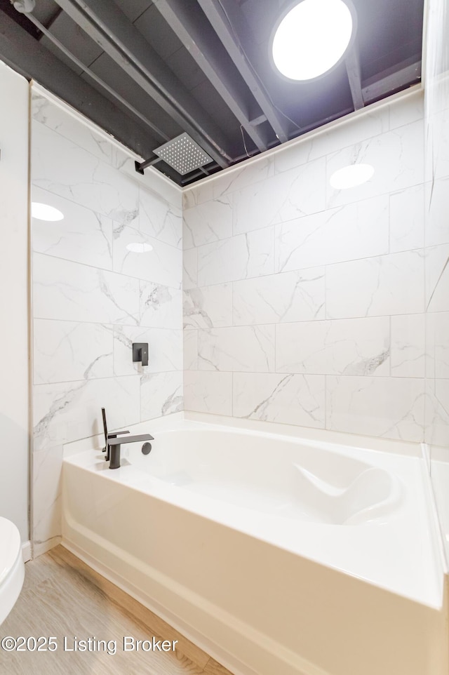 full bathroom featuring bathtub / shower combination, toilet, and wood finished floors