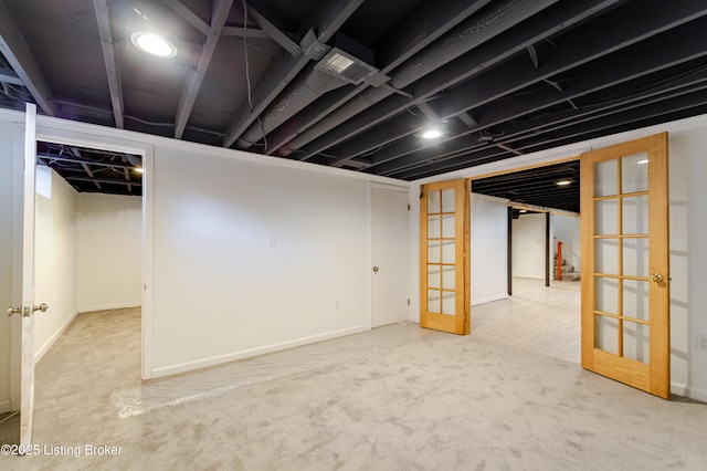 finished basement with carpet, french doors, and visible vents