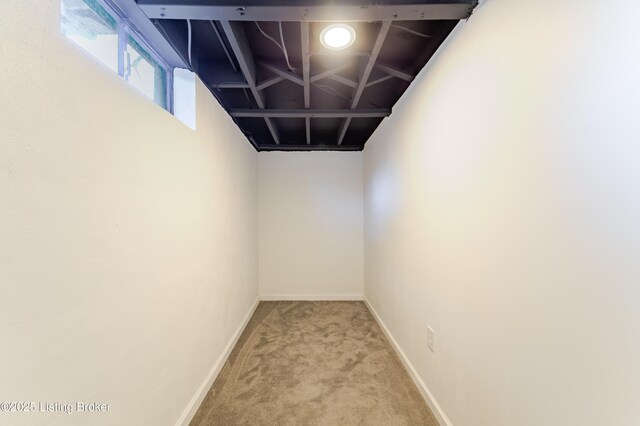 basement with carpet flooring and baseboards