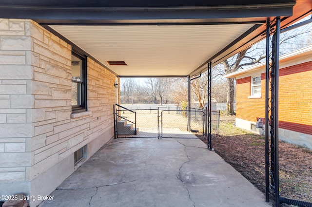 view of patio with a carport, fence, and a gate