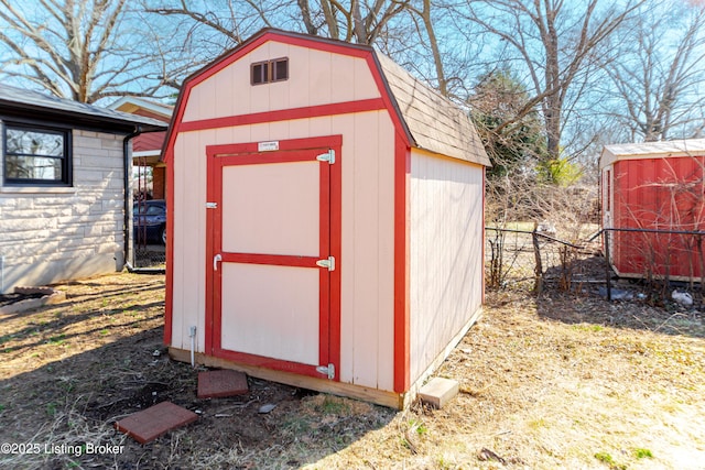 view of shed with fence