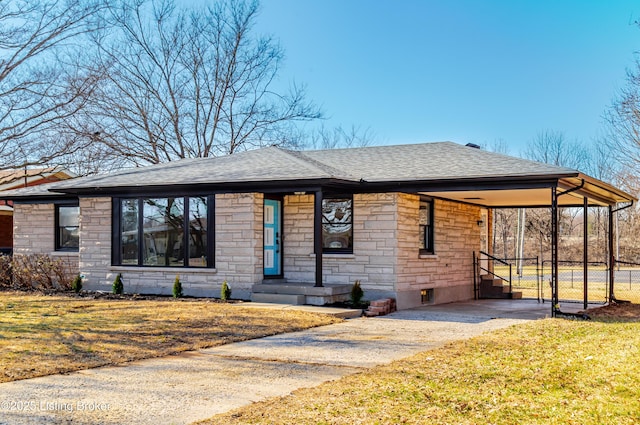 view of front of home with stone siding, a shingled roof, fence, and concrete driveway