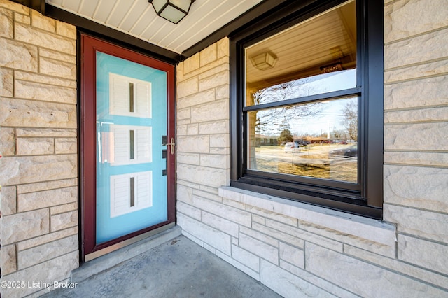 doorway to property featuring stone siding