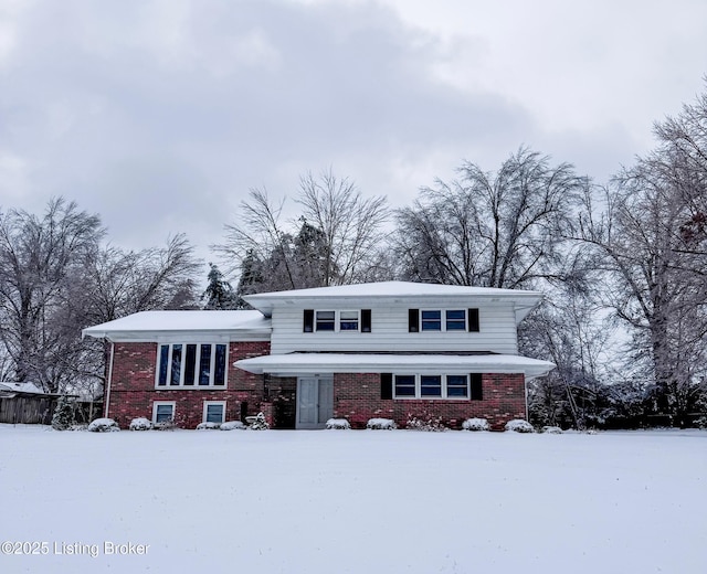 split level home featuring brick siding