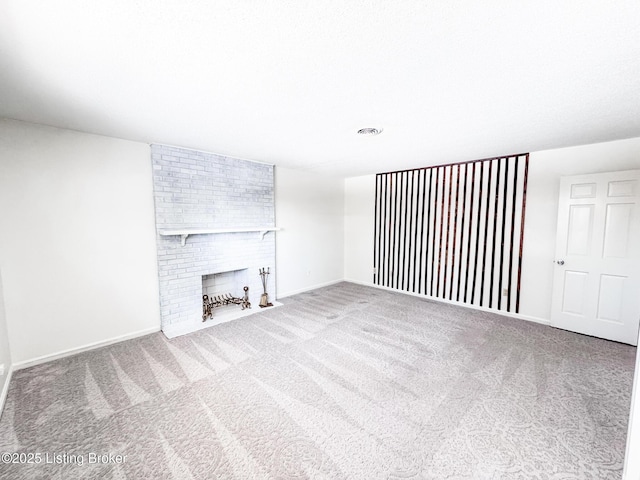 unfurnished living room featuring a fireplace, carpet flooring, and visible vents