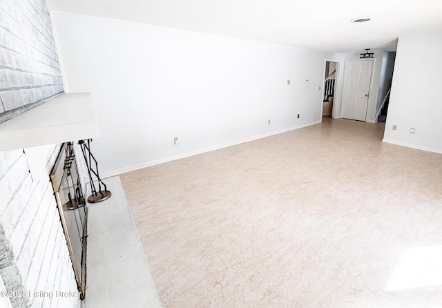 unfurnished living room with visible vents and baseboards