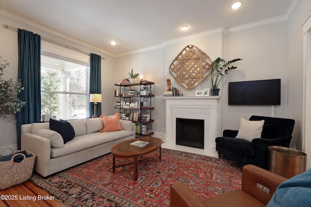 living area featuring ornamental molding, recessed lighting, a fireplace, and wood finished floors