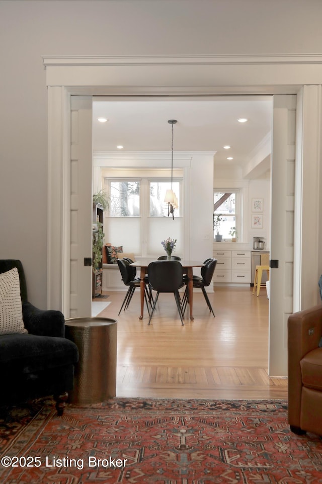 dining space featuring ornamental molding, wood finished floors, and recessed lighting