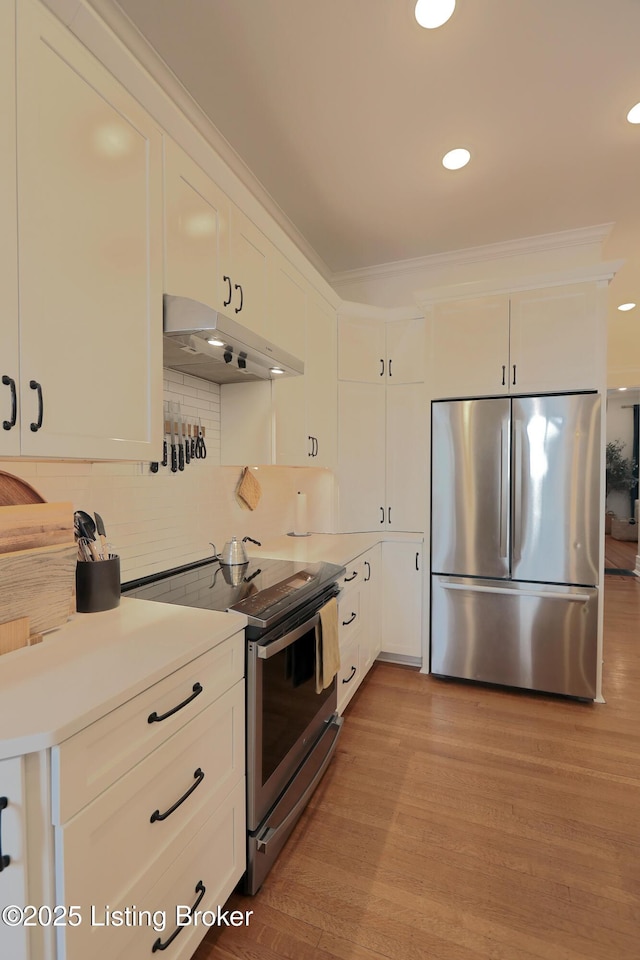 kitchen featuring stainless steel appliances, light countertops, white cabinets, and under cabinet range hood