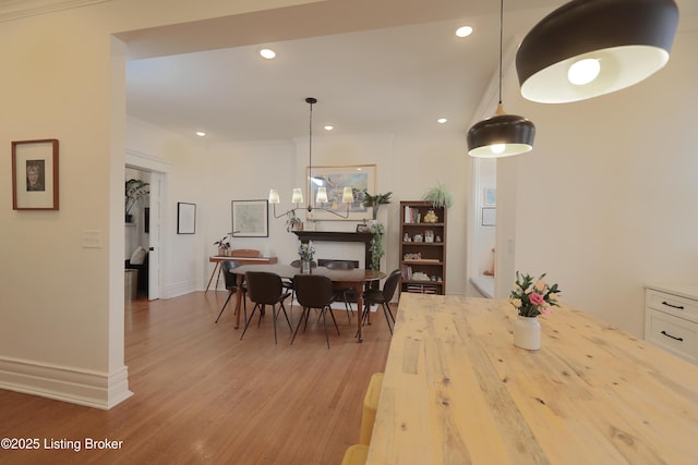 dining area with baseboards, a chandelier, wood finished floors, and recessed lighting