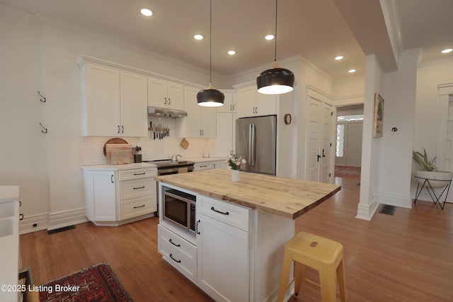 kitchen featuring appliances with stainless steel finishes and white cabinets