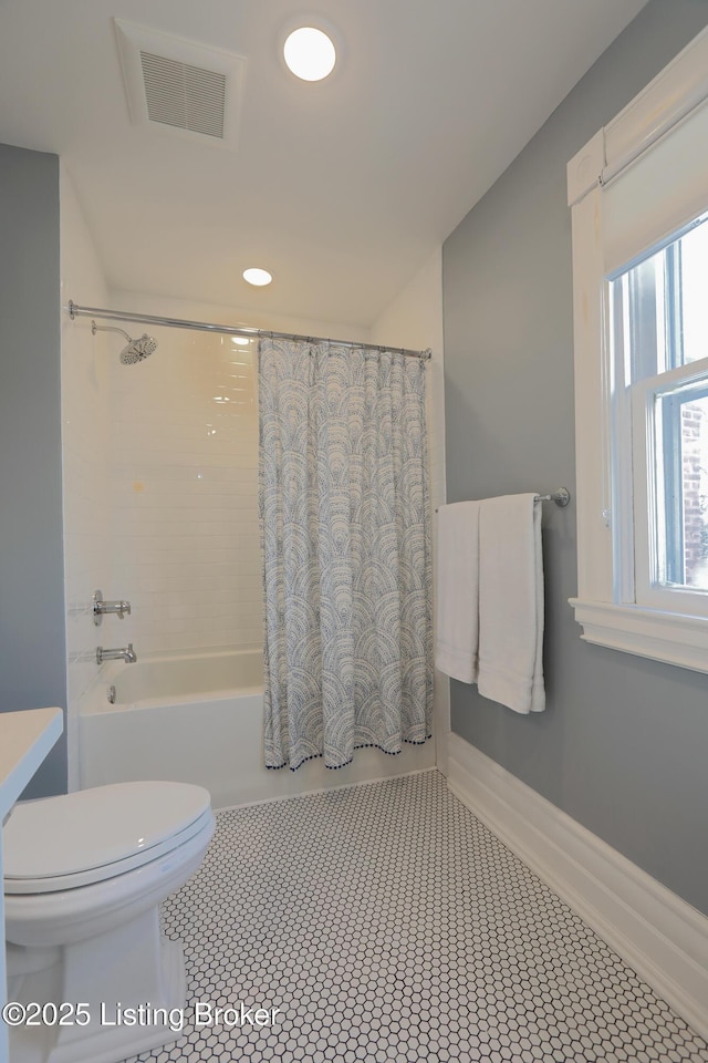 full bath with visible vents, shower / bathtub combination with curtain, toilet, tile patterned flooring, and baseboards