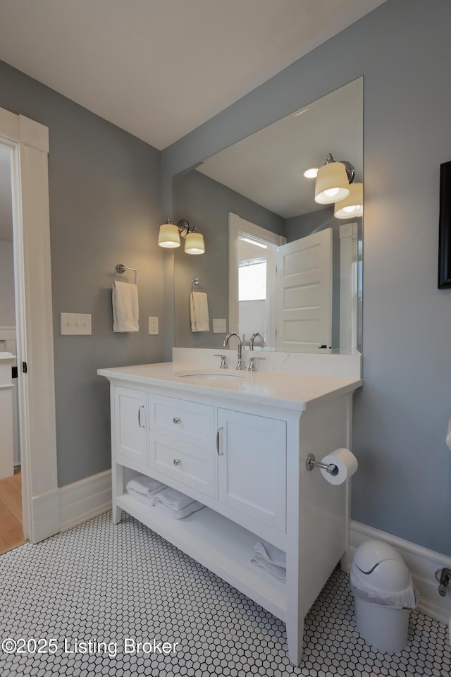 bathroom featuring vanity, baseboards, and tile patterned floors