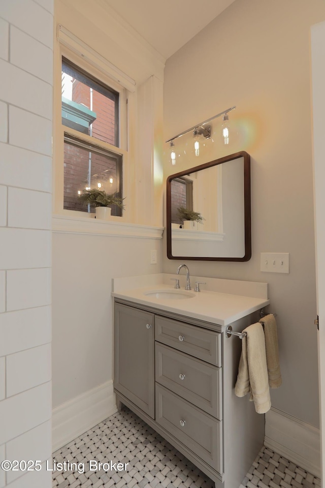 bathroom featuring tile patterned flooring, vanity, and baseboards