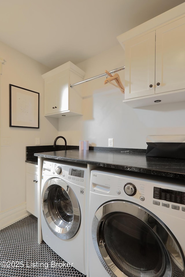 clothes washing area with cabinet space, independent washer and dryer, and baseboards