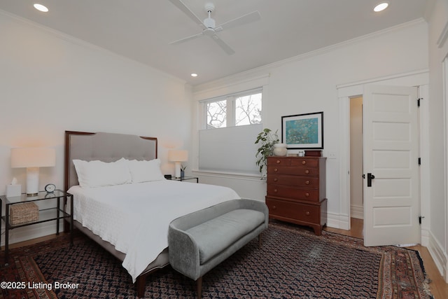 bedroom with baseboards, dark wood finished floors, crown molding, and recessed lighting