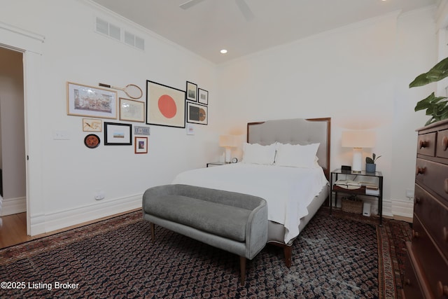 bedroom featuring ornamental molding, a ceiling fan, visible vents, and baseboards